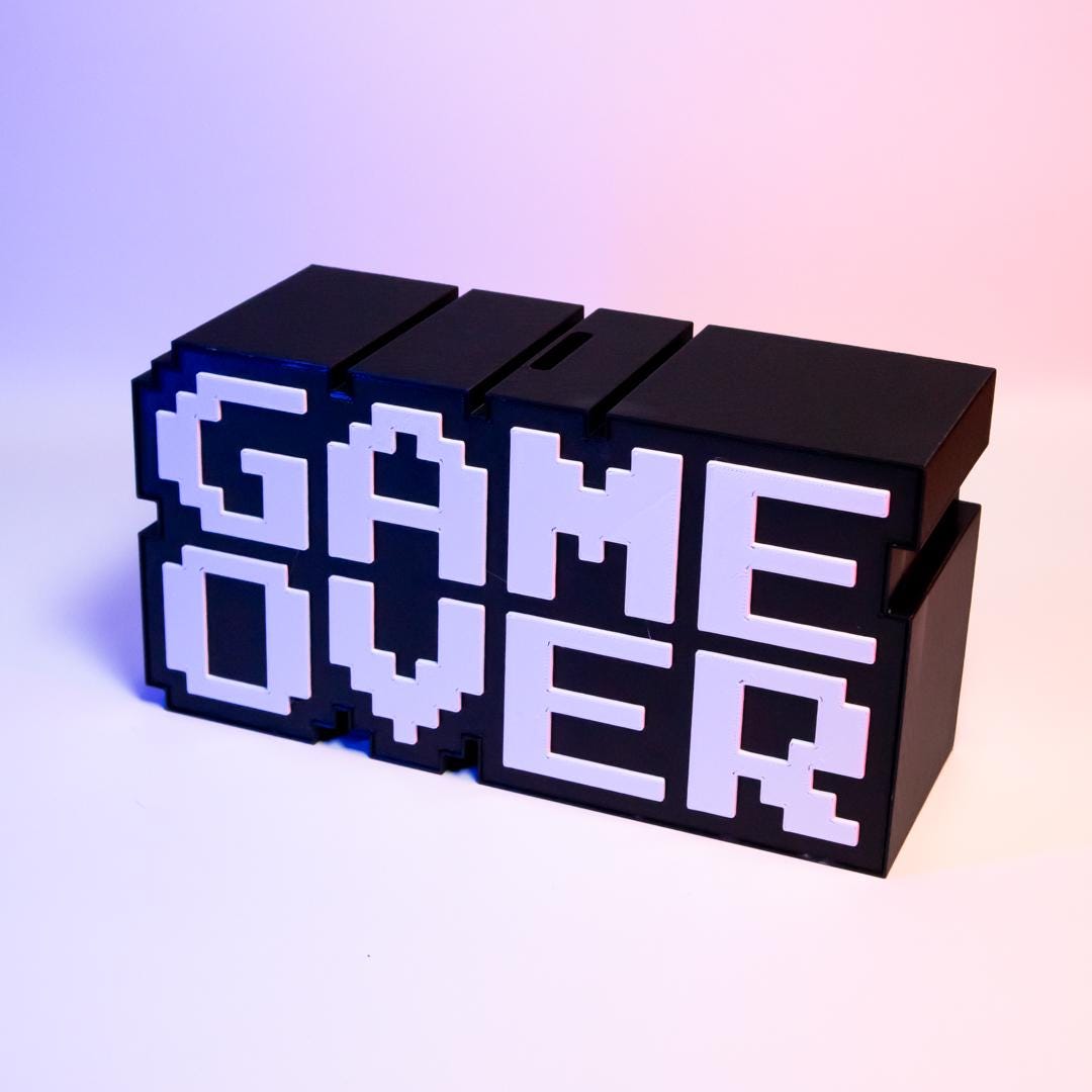 Game Over Piggy Bank Fun Gaming-Themed Savings Bank Unique Desk Decor Perfect Gift for Gamers Retro Arcade Style Coin Bank