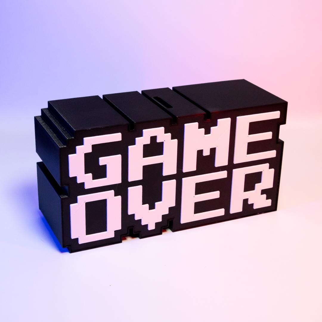 Game Over Piggy Bank Fun Gaming-Themed Savings Bank Unique Desk Decor Perfect Gift for Gamers Retro Arcade Style Coin Bank